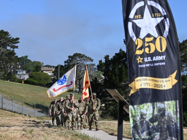 Col. Stephen Trotter, commander of U.S. Army Fort Hunter Liggett, carries the Army Flag to Col. Dan Artino, commander of the U.S. Army Garrison Presidio of Monterey, during a special ceremony celebrating two and a half centuries of service,...