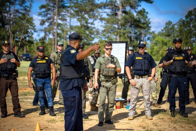 Metz Luchey, operations patrol captain at Fort Eisenhower's Law Enforcement Center, gives instructions to law enforcement officers from across the Central Savannah River Area participating in a shooting competition at Range 8 on Fort...