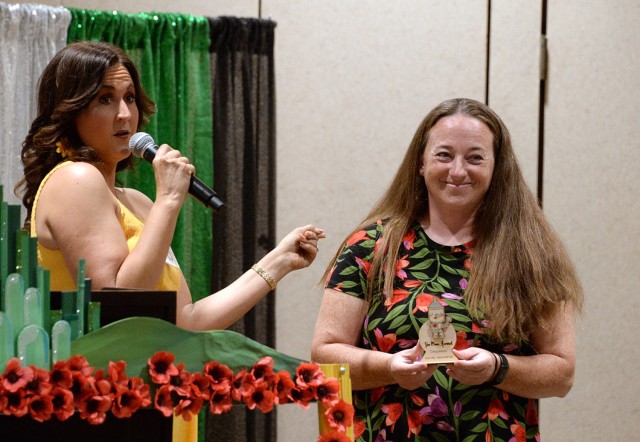 Fort Leavenworth Spouses' Club President Karly Gadell recognizes FLSC Historian Rachel Naramore with a “Tin Man” award for leading with empathy and heart May 14, 2025, at the Frontier Conference Center at Fort Leavenworth, Kansas. Gadell...