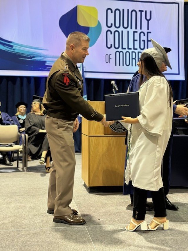 RANDOLPH, N.J. - Maj. Gen. John T. Reim, Picatinny Arsenal Commanding General and Joint Program Executive Officer Armaments and Ammunition, congratulates a graduate during the County College of Morris 2025 graduation ceremony on May 22.