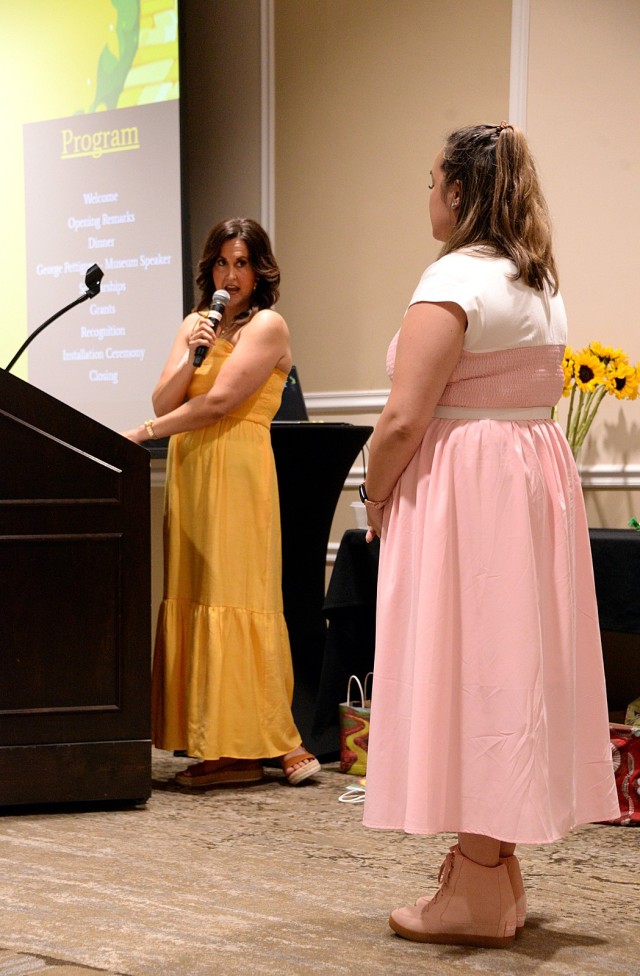 Fort Leavenworth Spouses' Club President Karly Gadell explains the mission of the Tragedy Assistance Program for Survivors as she presents a FLSC community grant to TAPS representative Brigette Berlanga, sister of fallen soldier Sgt. David...