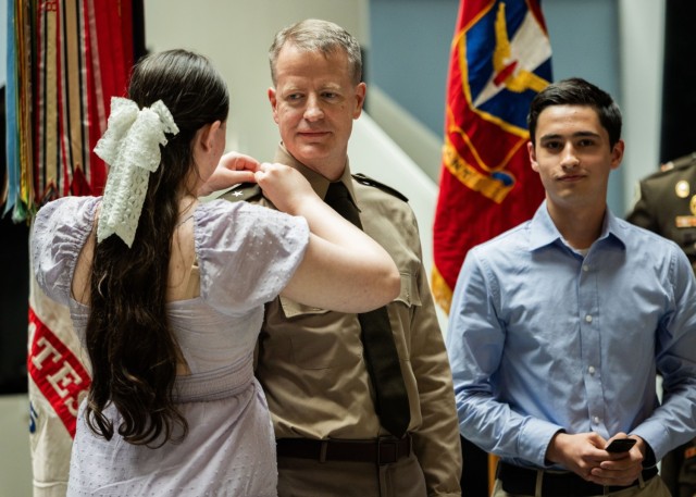 Family members of U.S. Army Col. Glenn A. Henke pin brigadier general insignia on his uniform during a frocking ceremony at the Air Defense Artillery Training Support Facility at Fort Sill, Okla. May 21, 2025. Henke was selected for promotion in...
