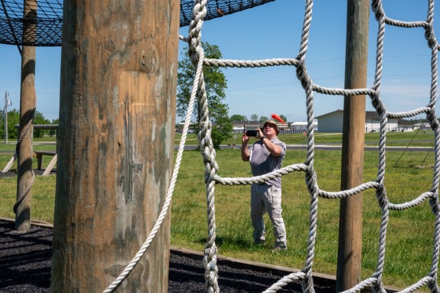 Craig Reeves, U.S. Army Fort Leonard Wood Garrison Safety specialist, takes photos of the Tough One obstacle during a safety inspection May 20 at Camp Crowder’s obstacle course. Camp Crowder is a Missouri National Guard training center located...