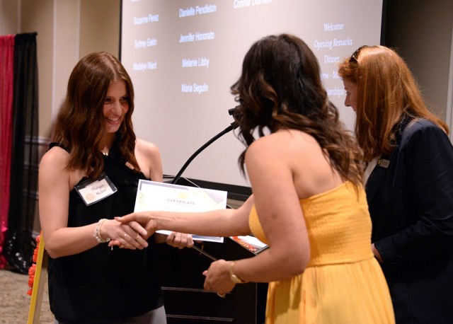 Fort Leavenworth Spouses’ Club President Karly Gadell and Scholarship Chairperson Laura Brown present Morgan Miller with a scholarship during the FLSC awards and recognition night May 14, 2025, at the Frontier Conference Center at Fort...