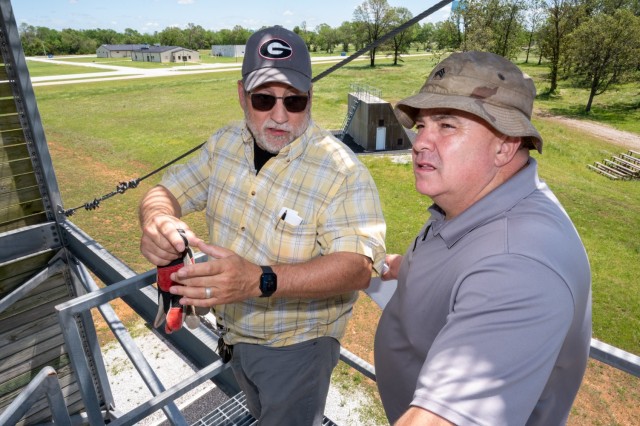 U.S. Army Fort Leonard Wood Garrison Safety specialists, Bradley Hilton, left, and Craig Reeves, right, discuss safety inspection findings of a 40-foot rappel tower May 20 at Camp Crowder, a Missouri National Guard training center located about...
