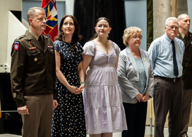 Family members of U.S. Army Col. Glenn A. Henke prepare to pin brigadier general insignia on his uniform during a frocking ceremony at the Air Defense Artillery Training Support Facility at Fort Sill, Okla. May 21, 2025. Henke was selected for...
