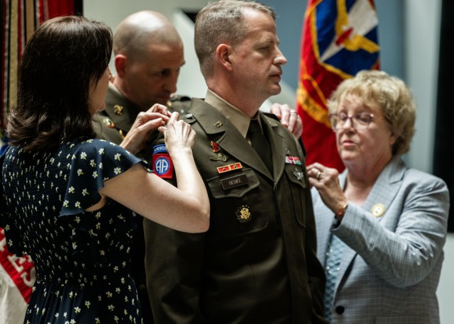 Family members of U.S. Army Col. Glenn A. Henke pin brigadier general insignia on his uniform during a frocking ceremony at the Air Defense Artillery Training Support Facility at Fort Sill, Okla. May 21, 2025. Henke was selected for promotion in...