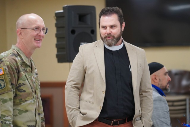 Lt. Col. Douglas Yates, chaplain for the U.S. Army Tank-automotive and Armaments Command, and Rev. Todd Meyer, rector of Mariners&#39; Church of Detroit, talk during the prayer breakfast.