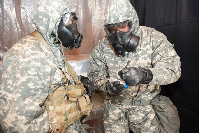 During the 2024 Best Chemical, Biological, Radiological and Nuclear Warrior Competition, Sgt. 1st Class David Beals marks a test tube during an event designed to test competitors on their ability to use CBRN equipment to collect liquid chemical...