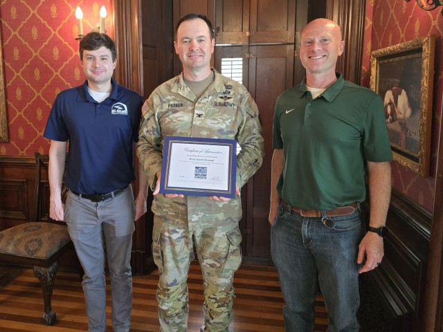 Zachary Sutton of the Bi-State Regional Commission and Greg Schaapveld, vice president of the QC Riverfront Council, present Col. Joe Parker with a Certificate of Achievement for the Rock Island Arsenal’s efforts in the community.