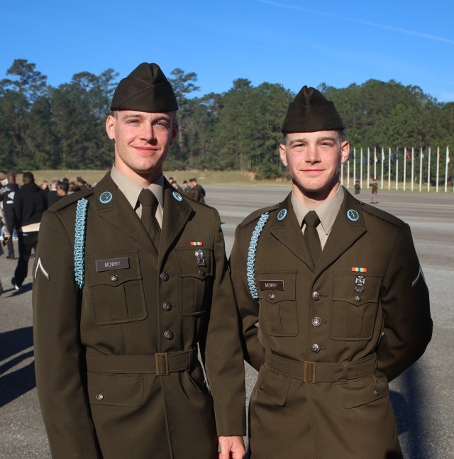 Privates Kyle and Gavin Mowry with Delta Company, 2nd Battalion, 29th Infantry Regiment, 197th Infantry Brigade, pose for a photo after receiving their blue cords during a Turning Blue Ceremony March 19, 2025, at Kanell Field on Fort Benning,...