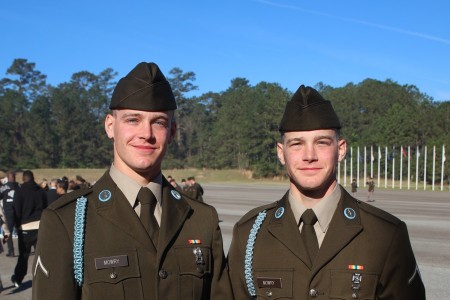 Privates Kyle and Gavin Mowry with Delta Company, 2nd Battalion, 29th Infantry Regiment, 197th Infantry Brigade, pose for a photo after receiving their blue cords during a Turning Blue Ceremony March 19, 2025, at Kanell Field on Fort Benning,...