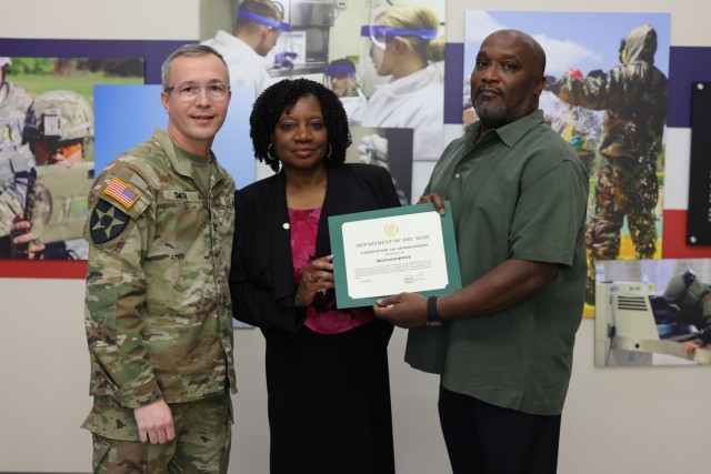 Col. Scott J. Smith (left), Angela D. Howze (center) and Reginald Howze (right)