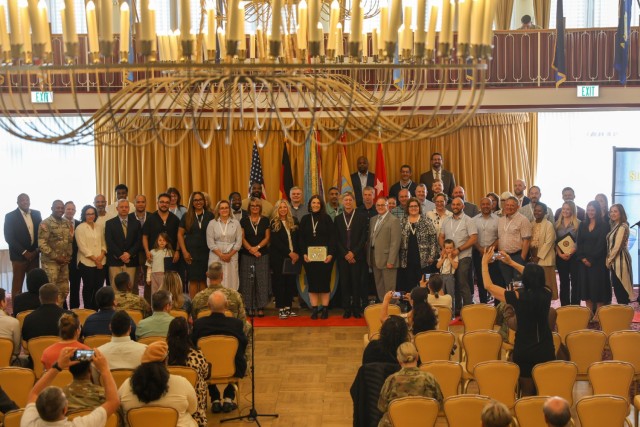 Length of Service honorees pose for a group photo following a recognition ceremony hosted by the 21st Theater Sustainment Command at the Armstrong Club, Vogelweh Military Complex, Kaiserslautern, Germany, May 15, 2025. The Civilian Length of...