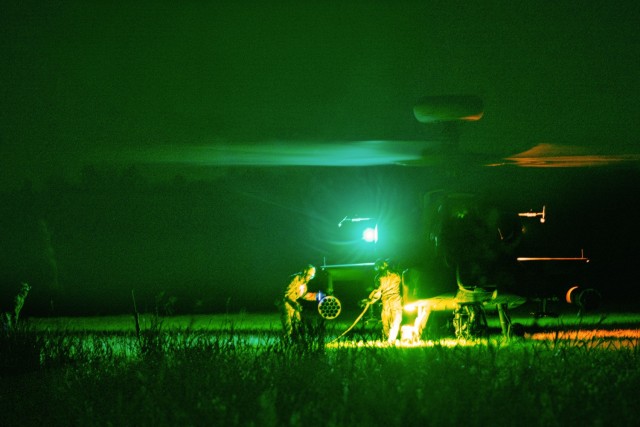 Soldiers with Distribution Platoon, Echo Company, 4th Battalion, 3rd Aviation Regiment, conduct nighttime refueling operations on an AH-64 Apache helicopter during Operation Brawler Phoenix at Preston Range, Fort Eisenhower, May 19, 2025.