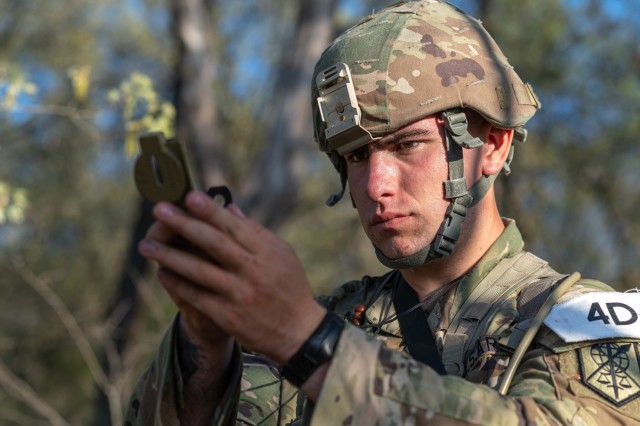 Army Reserve Best Squad competitor Pfc. Luke Griguolo, 200th Military Police Command, checks his compass during a land navigation event at Fort McCoy Wisconsin, May 10, 2025. 75 Soldiers from around the nation compete in the 2025 Army Reserve BSC,...