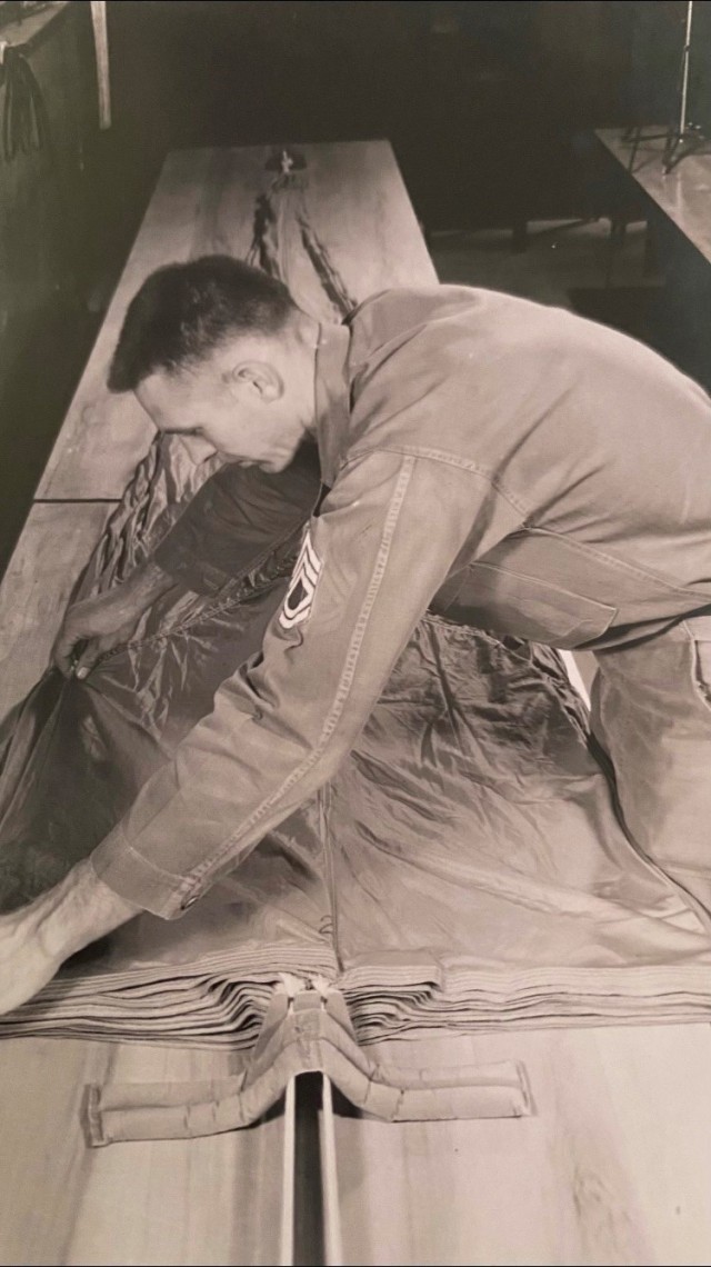 Back in 1958 each member of the team did it all, they were riggers, packers, and jumpers. Pictured here is Sgt 1st Class Williamson preparing his chute for another free-fall exercise.
