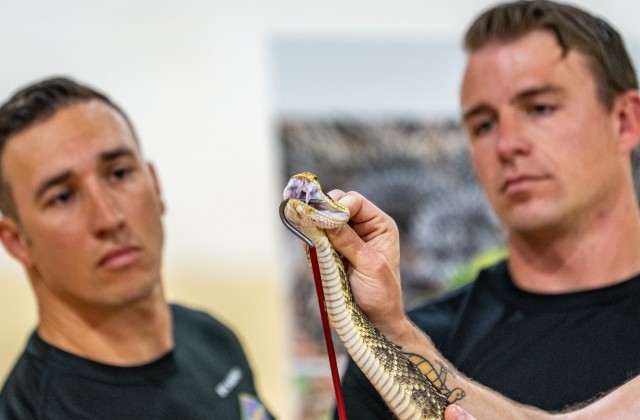 Sgt. 1st Class Andrew Karpati and Staff Sgt. Dillon Barbour, Ranger instructors with the 6th Ranger Training Battalion, Airborne and Ranger Training Brigade, participate in a reptile demonstration to the public during the 5th Ranger Training...