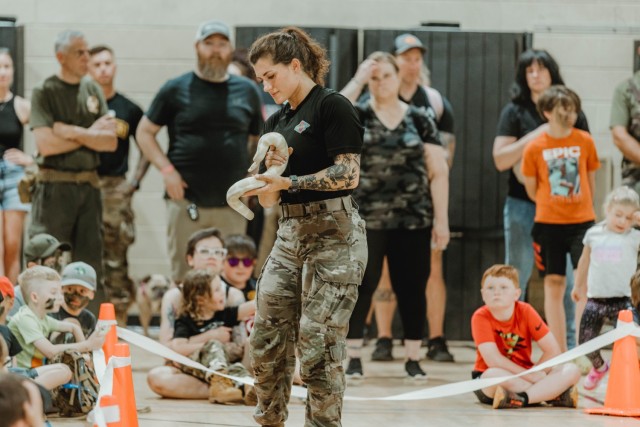 Staff Sgt. Julianne C. Jackson, a Ranger instructor with the 6th Ranger Training Battalion, Airborne and Ranger Training Brigade, participates in a reptile demonstration to the public during the 5th Ranger Training Battalion’s open house event...