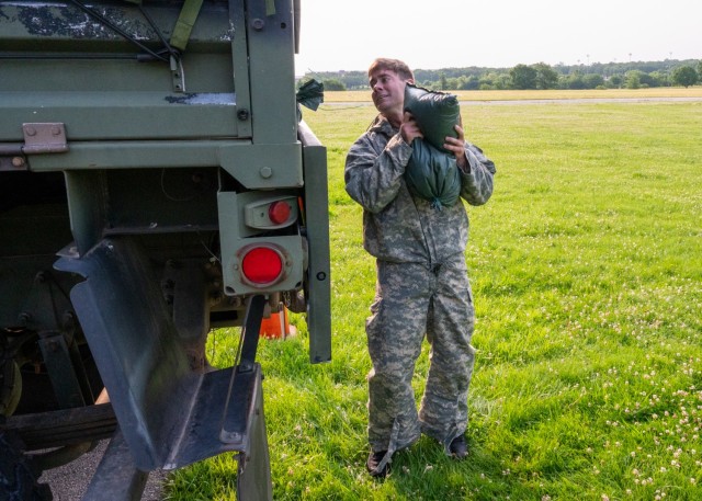 Staff Sgt. Joseph Stone, with the Defense Threat Reduction Agency, hurls a sandbag into the back of a truck during the Dragon Challenge portion of the 2025 Sgt. 1st Class Jeremiah W. Johnson Best Chemical, Biological, Radiological and Nuclear...