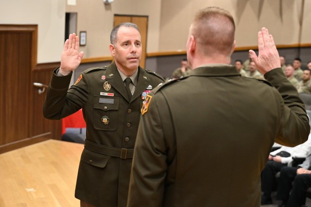 Newly frocked, Brig. Gen. Stephen Kolouch takes an oath, administered by Maj. Gen. Christopher Beck, Maneuver Support Center of Excellence and Fort Leonard Wood commanding general, during a ceremony May 29 in Lincoln Hall Auditorium.
