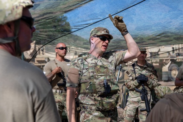 U.S. Army reservist Lt. Col. Robert Fincher, commander of 934th Forward Resuscitative Surgical Detachment, teaches his Soldiers the capabilities of specific camo netting that provides concealment from drones flying in the area during Exercise Global Medic, at Fort Hunter Liggett, California, on May 30, 2025. The Medical Readiness Training Command executes Exercise Global Medic as part of Operation Mojave Falcon focused on the 807th Theater Medical Command and Army Reserve Medical Command's larger mission to deliver relevant and realistic collective training to medical units and Soldiers preparing for large-scale combat operations.