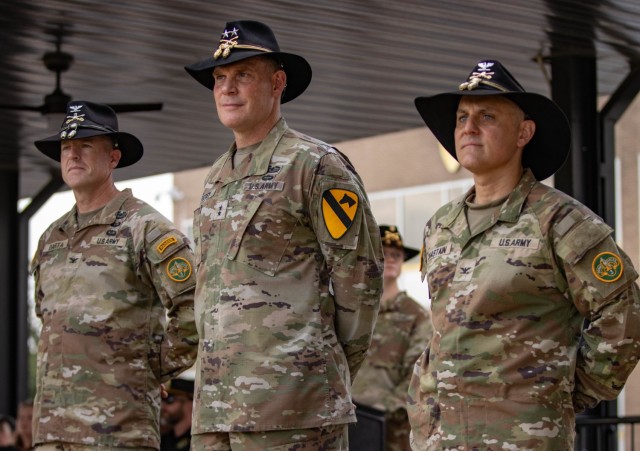 Commanding general of the 1st Cavalry Division, Maj. Gen. Thomas Feltey, as well as the incoming and outgoing regimental commanders of the 3d Cavalry Regiment, Col. William Chastain, and Col. Jeffrey Barta, stand at parade rest during a change of...
