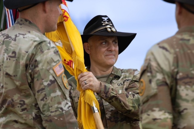 Commanding general of the 1st Cavalry Division, Maj. Gen. Thomas Feltey, passes the unit's colors to the incoming regimental commander of the 3d Cavalry Regiment, Col. William Chastain, during a change of command ceremony on Fort Cavazos, Texas,...