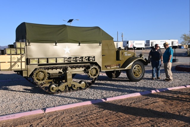 U.S. Army Yuma Proving Ground Training Exercise Management Office Chief Luis Arroyo (left) and retired Yuma Proving Ground Heritage Center curator Bill Heidner (right) examine a replica World War II era M3 half-track vehicle now on display outside...