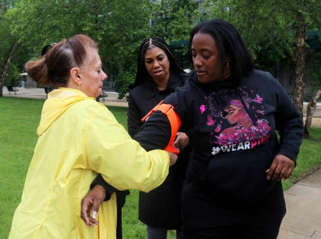 Myra Pilachouski, with Army Contracting Command - Aberdeen Proving Ground, left, applies a tourniquet on Tiffany Myatt, ACC-APG, right, while Denise Ralls, U.S. Army Communications-Electronics Command Software Engineering Center, middle, looks on...
