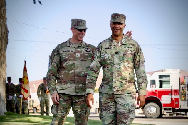 Brig. Gen. Brandon C. Anderson, Commanding General of Fort Irwin and the National Training Center, gives Col. Lane A. Bomar, the outgoing Fort Irwin Garrison Commander at the conclusion of the Fort Irwin Garrison change of command, June 10, 2025.