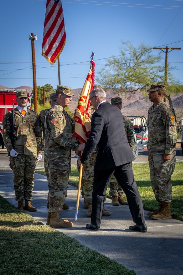 Mr. Patrick J. Appelman passes Fort Irwin&#39;s colors (flag) to Col. Steven L. Chadwick as he assumes command of the U.S. Army Garrison - Fort Irwin at the National Training Center, Ca June 10, 2025.
