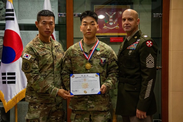(from left) Republic of Korea Sgt. Maj. Kim Yeong Jin, Korean Augmentation to the United States Army (KATUSA) Cpl. Woo Hyung Lee and Eighth Army Senior Enlisted Advisor Command Sgt. Maj. Robin Bolmer pose for a photo during the SAMC induction...