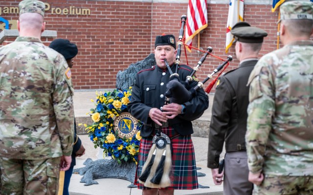 Dan Zacher performs solemn music on his bagpipe during the Sunrise Service, honoring fallen U.S. Army Chemical Corps Soldiers June 3 in Memorial Grove.