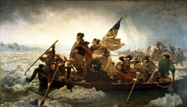 George Washington standing in the bow of a boat filled with soldiers rowing across the icy waters of the Delaware River on Christmas night 1776.