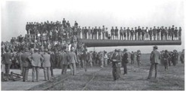 U.S. Army Soldiers stand with the “The Big Gun” in the early 1920s. Originally intended for use on battleships and then coastal defense at seaports between 1920-1946, this gun was built on APG in 1922 for testing purposes.