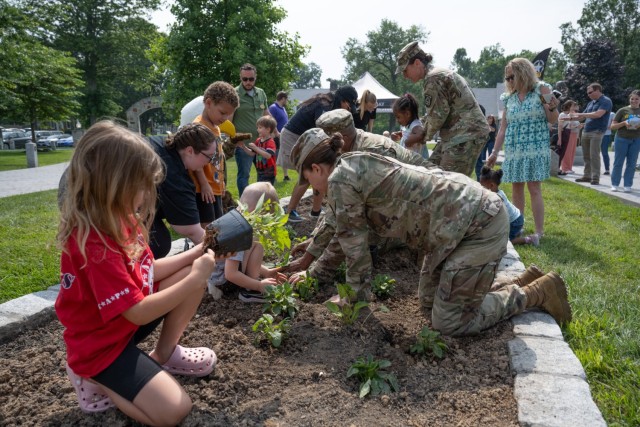 Community members plant flowers