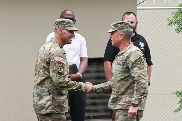 U.S. Army Brig. Gen. Sean Crockett, Acting Commander, Eighth Army, right, shakes hands with U.S. Army Command Sgt. Maj. Michael Eilers, 1-4 Stryker Brigade Combat Team senior enlisted advisor, shortly before a ribbon cutting ceremony held on Camp...