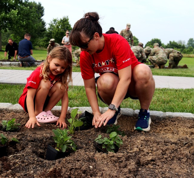 Mother and daughter plant flowers.
