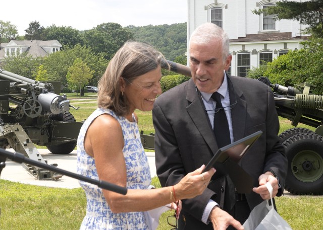 PICATINNY ARSENAL, N.J. - Christine Shields, widow of the late James Shields, and Chris Hatch, International Director (Weapons), Project Manager Combat Ammunition Systems, unveil a new Memorial Park in honor of Jim.