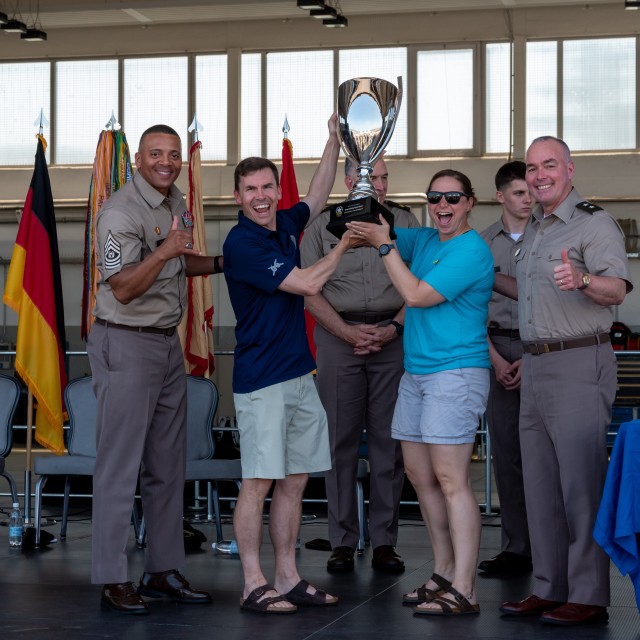 Army Col. Steven J. Curtis, commander of 66th Military Intelligence Brigade, and Command Sergeant Major Rose A. Shutts, senior enlisted advisor of 66th MIB, pose for a photo while holding the 2025 U.S. Army Garrison Wiesbaden, Army Birthday Sports...