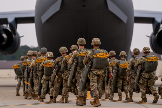 Paratroopers assigned to the 82nd Airborne Division walk to a C-17 Globemaster III before an airborne operation at Fort Bragg, North Carolina, March 13, 2025. The 82nd Airborne Division regularly conducts airborne operations as part of their...