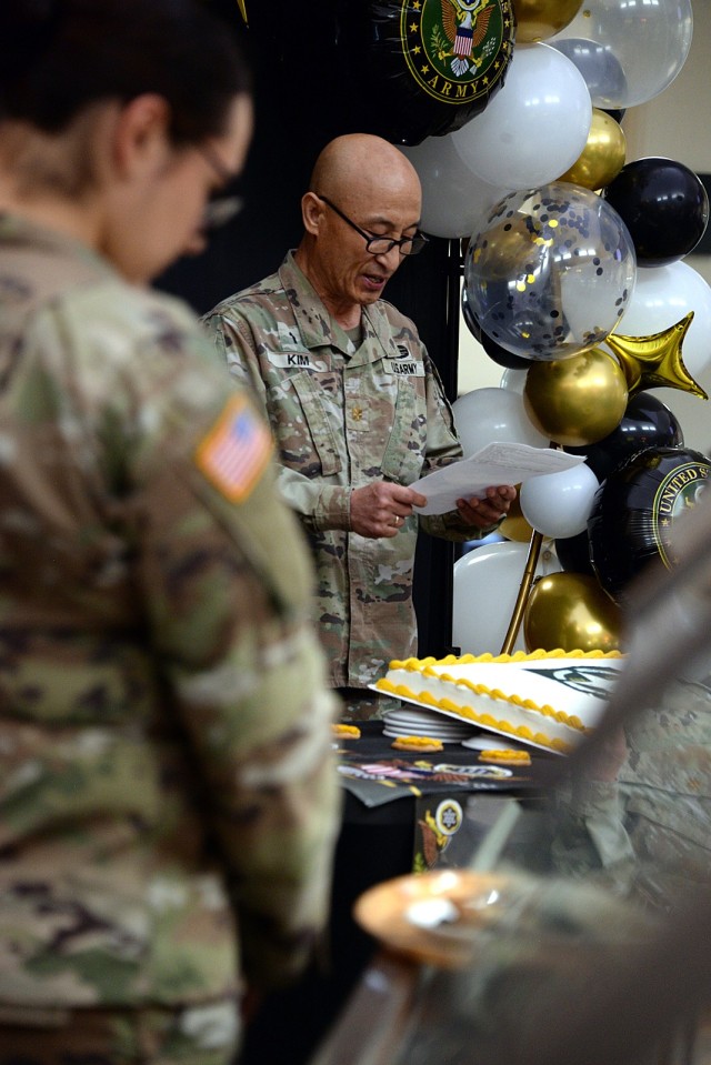 Pvt. Jasmine Santoscoy, Veterinary Treatment Facility, bows her head as Chaplain (Maj.) Abrahamyoungki Kim, chaplaincy resource manager, Religious Support Office, says a prayer at the Army birthday lunch and cake cutting June 13, 2025, at the Fort...