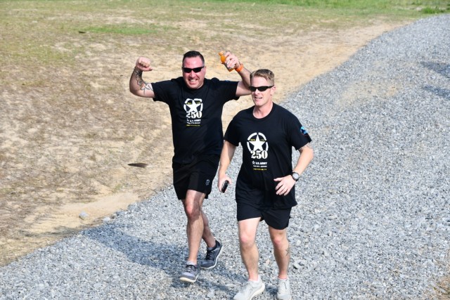 Command Sergeant Major Paul Jenkins cheers as he runs next to Garrison Commander Lieutenant Colonel Matthew Bauer