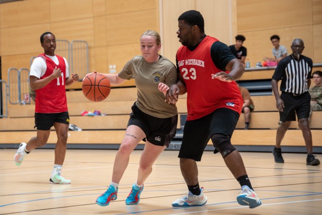 Two U.S. Army Soldiers  face off during a basketball game held as part of the U.S. Army Garrison Wiesbaden Commander’s Cup Sports Tournament on Lucius D. Clay Kaserne, Wiesbaden, Germany June 12, 2025. 
...