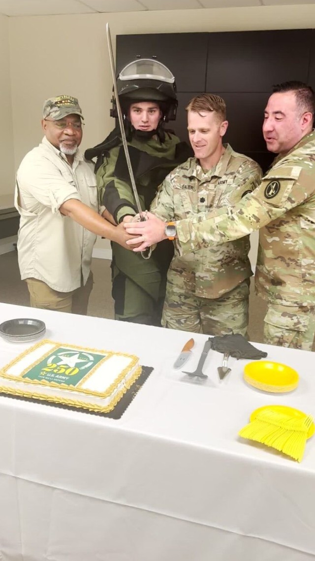 Sergeant First Class (Retired) Claude Triplett, Vietnam Veteran, Staff Sergeant Levi Newhouse, Lieutenant Colonel Matthew Bauer and Command Sergeant Major Paul Jenkins prepare to cut the Army 250th Birthday Cake