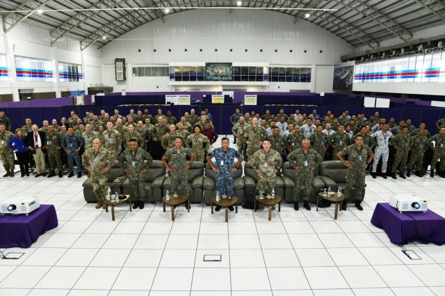 U.S. and Malaysian Armed Forces service members pose for a group photo during the Bersama Warrior 25 opening ceremony at the Joint Warfighting Center, Kuantan, Malaysia, June 17, 2025. Bersama Warrior is an annual, bilateral joint exercise...