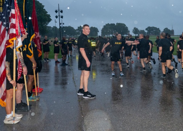 Maj. Gen. Christopher Beck, Maneuver Support Center of Excellence and Fort Leonard Wood commanding general (standing center) and MSCoE and Fort Leonard Wood Command Sgt. Maj. Jorge Arzabala (high fiving Soldiers) motivate runners as they finish...