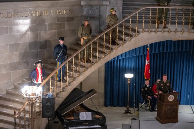 Maj. Gen. Christopher Beck, Maneuver Support Center of Excellence and Fort Leonard Wood commanding general speaks from the podium in the Rotunda of the Missouri Capitol in Jefferson City, June 12, while Fort Leonard Wood Soldiers, dressed in...