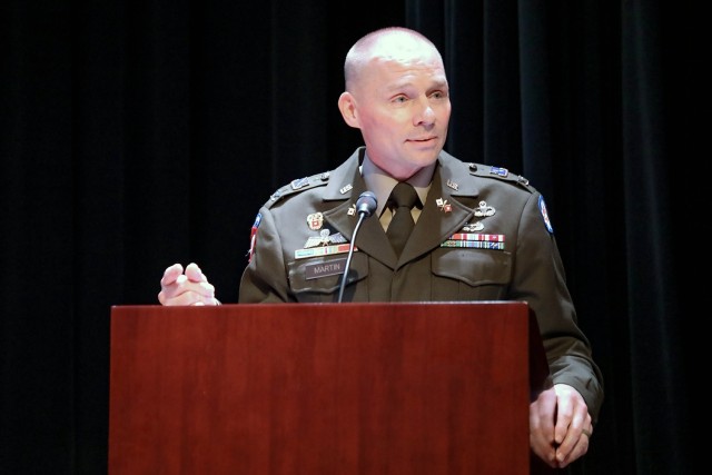 Col. William Martin stands at a podium and makes remarks during the change of command ceremony.